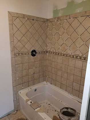 Construction of a tub and shower combination with tiled walls.